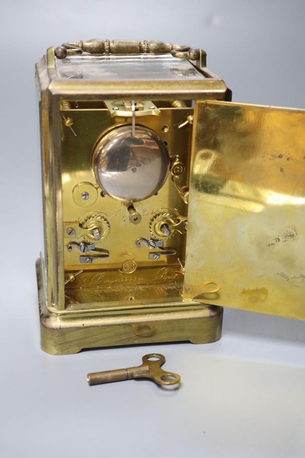O. Berger, Paris. A carriage clock, with white enamel dial, Japy Freres movement striking on a bell, 19cm incl. handle
